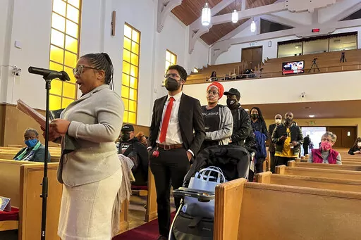 People line up to speak during a reparations task force meeting at Third Baptist Church in San Francisco on April 13, 2022.  A report by California's first in the nation task force on reparations Wednesday, June 1 will document in detail the harms perpetuated by the state against Black people and recommend ways to address those wrongs. (AP Photo/Janie Har, File)