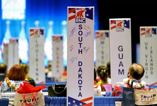 Delegates watch as the roll call vote of states continues after Vice President Mike Pence spoke at the 2020 Republican National Convention in Charlotte, N.C., Aug. 24, 2020. Many state Republican parties made changes to their rules ahead of the 2020 election by adding more winner-take-all contests and requiring candidates to earn higher percentages of the vote to claim any delegates. (AP Photo/Andrew Harnik, File)