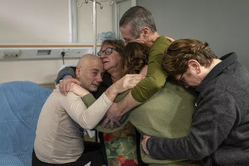 Hostage Luis Har, left, is hugged by relatives after being rescued from captivity in the Gaza Strip, at the Sheba Medical Center in Ramat Gan, Israel, Monday, Feb. 12, 2024. Israeli forces rescued two hostages early Monday, storming a heavily guarded apartment in the Gaza Strip and extracting the captives under fire in a dramatic raid that was a small but symbolically significant success for Israel. Marman was taken hostage by Hamas in cross-border attack in October last year. (Israeli Army via 