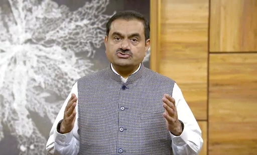 This grab from video released by Adani Enterprises ltd on Thursday, Feb.2, 2023 shows Indian billionaire Gautam Adani addressing investors from an unknown location. Adani called off his flagship company's $2.5 billion share sale late Wednesday after a tumultuous week saw his conglomerate shed tens of billions of dollars in market value after claims of fraud from a U.S.-based short-selling firm. (Adani Enterprises ltd via AP)