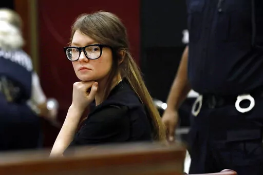 FILE — Anna Sorokin sits at the defense table during jury deliberations in her trial at New York State Supreme Court, April 25, 2019, in New York. Sorokin, whose exploits inspired a Netflix series, has been released from immigration custody into home confinement, a spokesperson said Saturday, Oct. 8, 2022.  (AP Photo/Richard Drew, File)