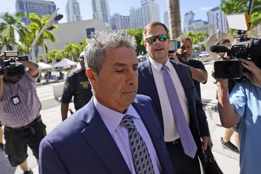 Carlos De Oliveira, center, an employee of Donald Trump's Mar-a-Lago estate, arrives for a court appearance with attorney John Irving, at the James Lawrence King Federal Justice Building, Monday, July 31, 2023, in Miami. De Oliveira, Mar-a-Lago's property manager, was added last week to the indictment with Trump and the former president's valet, Walt Nauta, in the federal case alleging a plot to illegally keep top-secret records at Trump's Florida estate and thwart government efforts to retrieve
