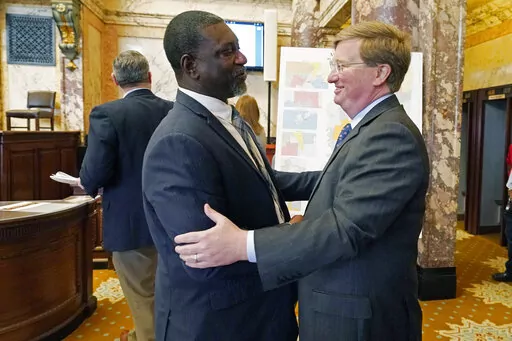 Sen. Juan Barnett, D-Heidelberg, left, welcomes Mississippi Gov. Tate Reeves to the chamber at the Mississippi Capitol in Jackson, Miss., Friday, April 1, 2022. A number of lawmakers greeted the governor as he dropped by to observe the body in session. (AP Photo/Rogelio V. Solis)