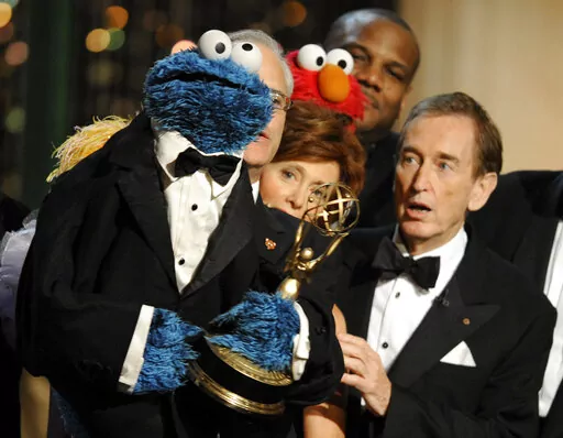 Bob McGrath, right, looks at the Cookie Monster as they accept the Lifetime Achievement Award for '"Sesame Street" at the Daytime Emmy Awards on Aug. 30, 2009, in Los Angeles. McGrath, an actor, musician and children’s author widely known for his portrayal of one of the first regular characters on the children’s show “Sesame Street” has died at the age of 90. McGrath’s passing was confirmed by his family who posted on his Facebook page on Sunday, Dec. 4, 2022. (AP Photo/Chris Pizzello,