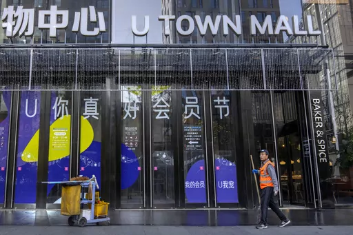 A worker mops the floor at the entrance to a shopping mall in Beijing, Tuesday, April 18, 2023. China’s economy grew 4.5% in the first quarter of the year, boosted by increased consumption and retail sales, after authorities abruptly abandoned the stringent "zero-COVID" strategy. (AP Photo/Mark Schiefelbein)