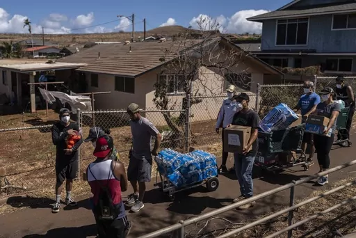 Volunteers make food, bottle water and supply deliveries to elderly residents impacted by a devastating wildfire in Lahaina, Hawaii, Aug. 19, 2023. Residents of Maui are eager to learn when they can expect safe drinking water to be restored in the wake of last month’s catastrophic wildfires, but extensive testing is still needed and officials are urging patience. (AP Photo/Jae C. Hong, File)