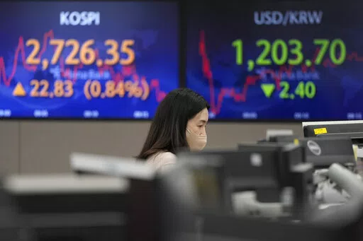 A currency trader watches monitors at the foreign exchange dealing room of the KEB Hana Bank headquarters in Seoul, South Korea, Thursday, March 3, 2022. Asian stock markets rebounded Thursday and oil prices climbed higher after the head of the Federal Reserve said he supports a smaller rise in interest rates than some expected. (AP Photo/Ahn Young-joon)