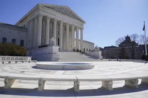People stand on the steps of the U.S. Supreme Court, Feb.11, 2022, in Washington. The Supreme Court has agreed to take up a dispute over a medication used in the most common method of abortion in the United States. It’s the court’s first abortion case since it overturned Roe v. Wade last year. (AP Photo/Mariam Zuhaib, File)