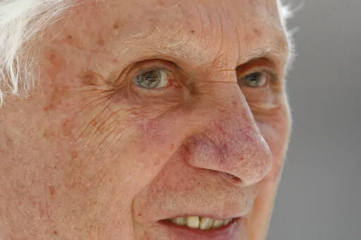 Pope Benedict XVI smiles during a Mass in St. Peter's Square celebrated by 15,000 white-robed priests, all marking the end of the Vatican's Year of the Priest, on June 11, 2010. Pope Benedict XVI rarely got credit for having turned the Vatican around on clergy sexual abuse, but as cardinal and pope, he pushed through revolutionary changes to church law to make it easier to defrock predator priests. (AP Photo/Pier Paolo Cito, File)