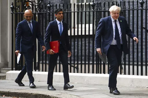 From left, British Health Secretary Sajid Javid, Chancellor of the Exchequer Rishi Sunak and Prime Minister Boris Johnson arrive at No 9 Downing Street for a media briefing on May 7, 2021. The contest to succeed British Prime Minister Boris Johnson has no single frontrunner but there are many prominent contenders.  (Toby Melville/PA via AP, file)