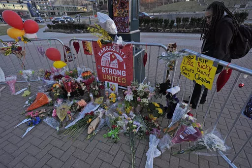 A person views a memorial dedicated to the victims of last week's mass shooting in front of Union Station, Sunday, Feb. 18, 2024, in Kansas City, Mo. Missouri prosecutors said Tuesday, Feb. 20, that two men have been charged with murder in last week’s shooting that killed one person and injured multiple others after the Kansas City Chiefs’ Super Bowl parade. (AP Photo/Charlie Riedel, File)