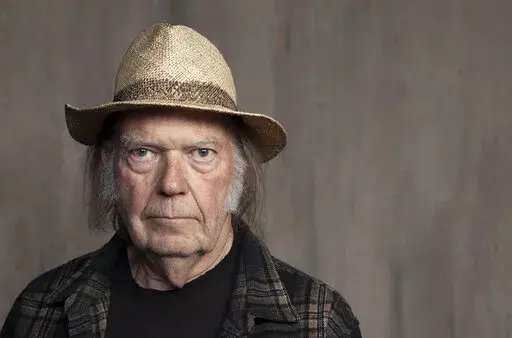 Neil Young poses for a portrait at Lost Planet Editorial in Santa Monica, Calif. on Sept. 9, 2019.  Young isn't satisfied with urging his fellow musicians to join him in taking their music off the streaming service Spotify. Now he wants company employees to quit their jobs before it “eats up your soul." In a message on his website Monday, Feb. 7, 2022, Young said company CEO Daniel Ek is a bigger problem than popular podcaster Joe Rogan.  (Photo by Rebecca Cabage/Invision/AP, File)